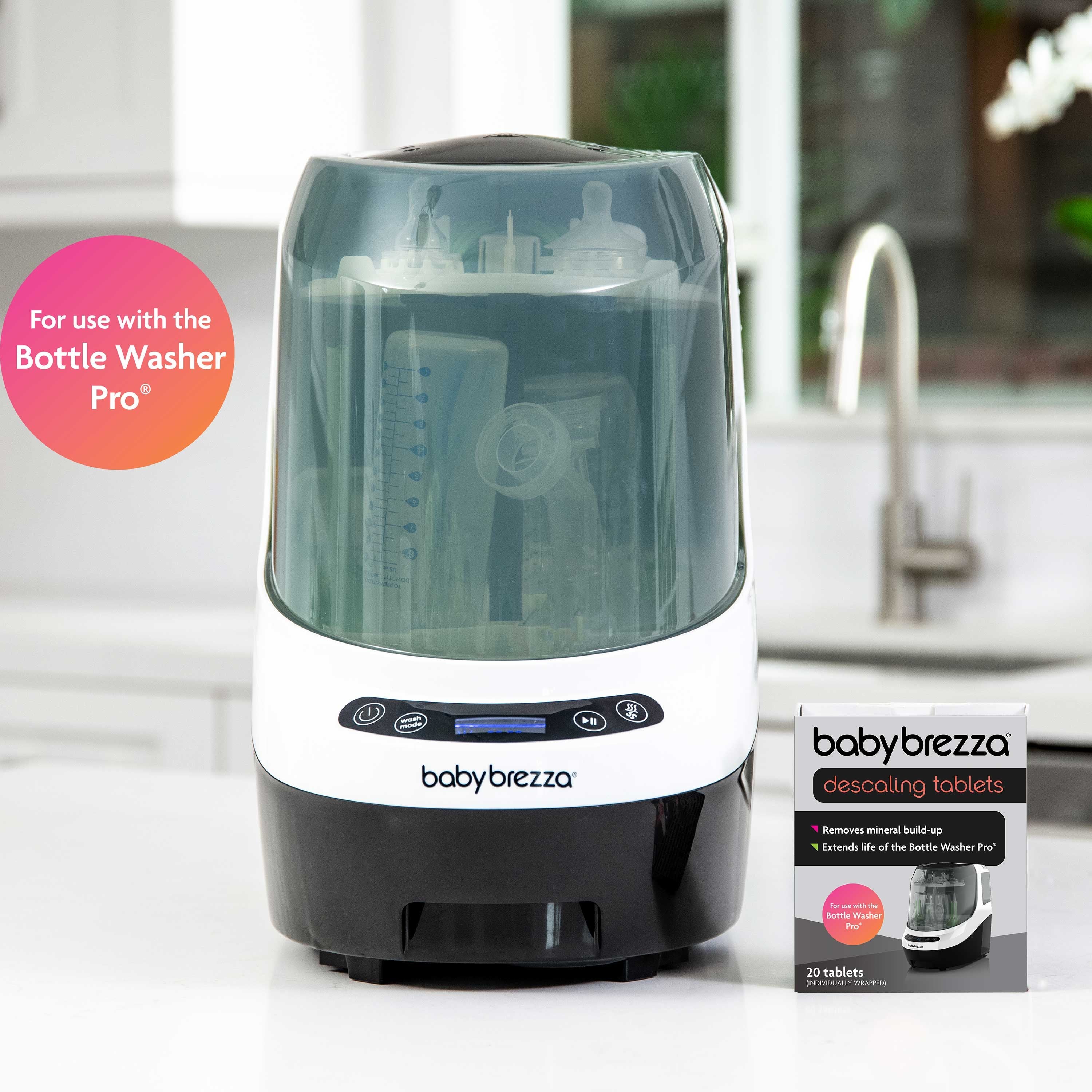 A Baby Brezza Bottle Washer Pro with bottles sits on a kitchen counter. Next to it is a box of Baby Brezza UK Bottle Washer Pro Descaling Tablets, designed to remove limescale. Text bubble: For use with the Bottle Washer Pro. - product thumbnail