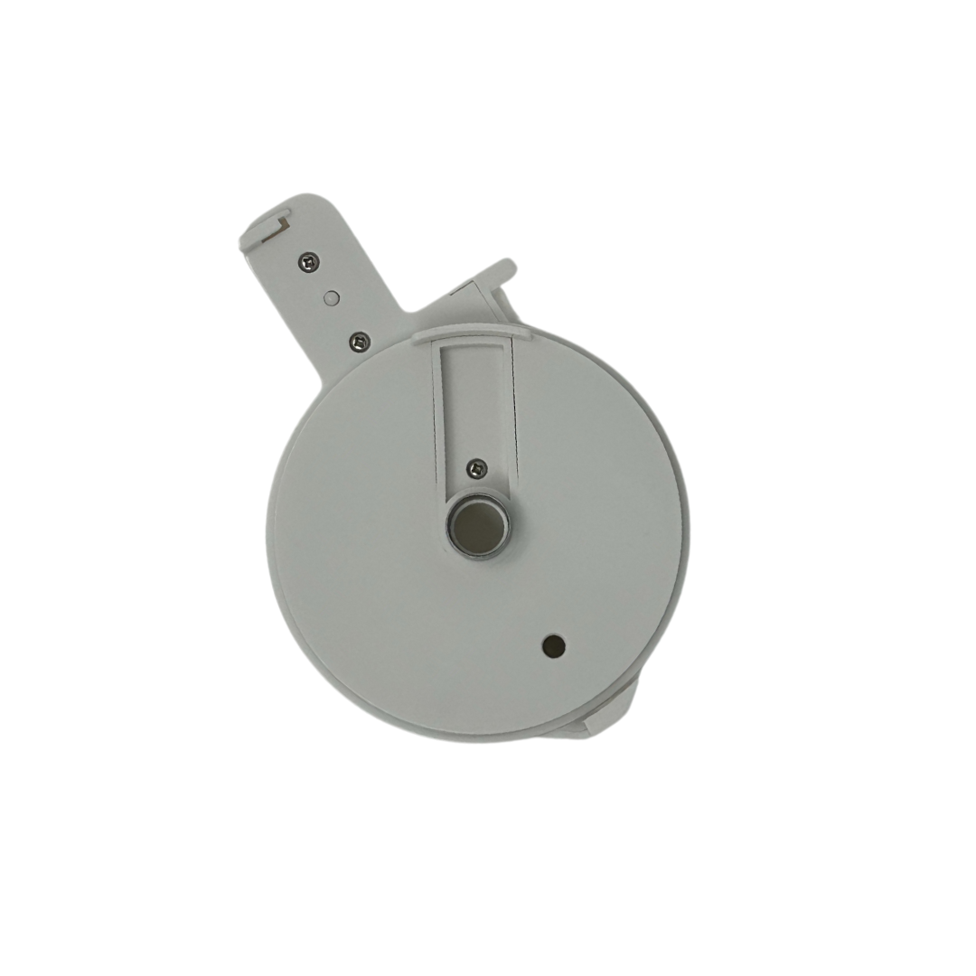 A top-down view of the Baby Brezza UK Food Maker Deluxe Replacement Bowl Lid, a round, light gray plastic lid with a protruding handle, small circular button or sensor, visible screws, and a sleek minimalistic design. - product thumbnail