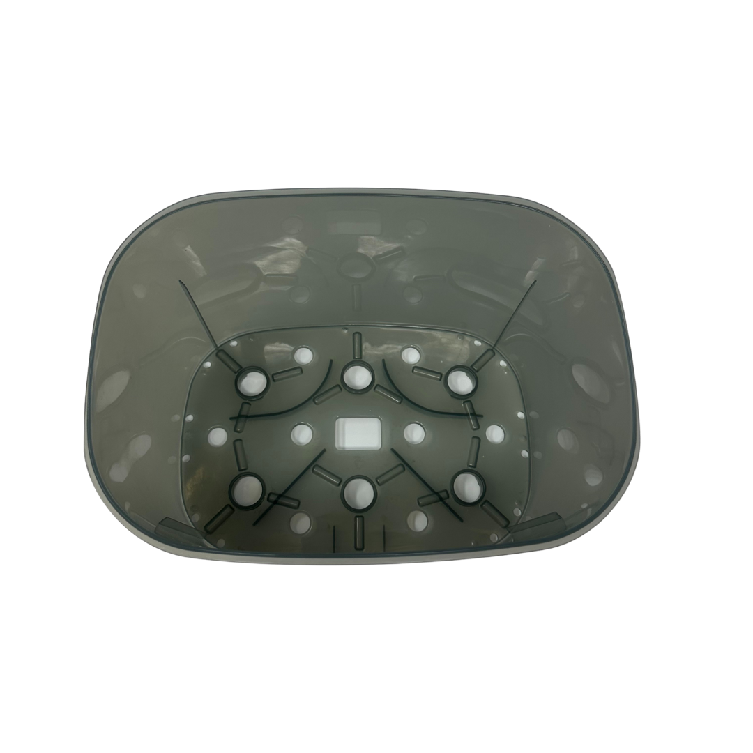 The Baby Brezza UK Steriliser Dryer Replacement Large Basket is a translucent, rectangular plastic container with rounded corners and a patterned base designed for the Steriliser Dryer Advanced. - product thumbnail