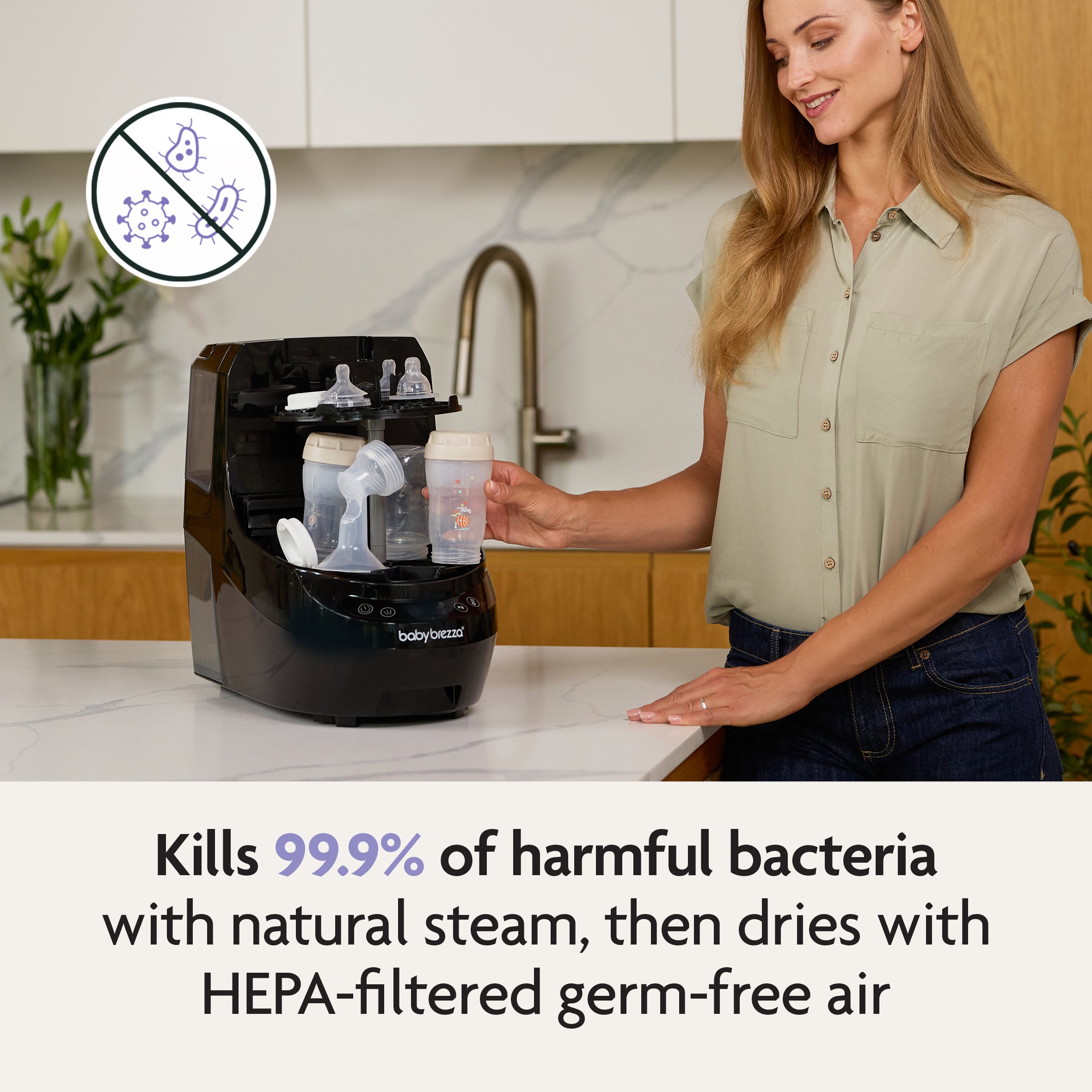 #variant_black Woman using a Baby Brezza bottle washer with text highlighting its germ-killing capabilities. - product thumbnail