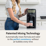 A woman fills a baby bottle using the Baby Brezza UK BUNDLE Formula Pro Advanced And SuperQuick Steriliser in all black, which features patented technology for perfectly mixing formula and water without air bubbles. - product thumbnail