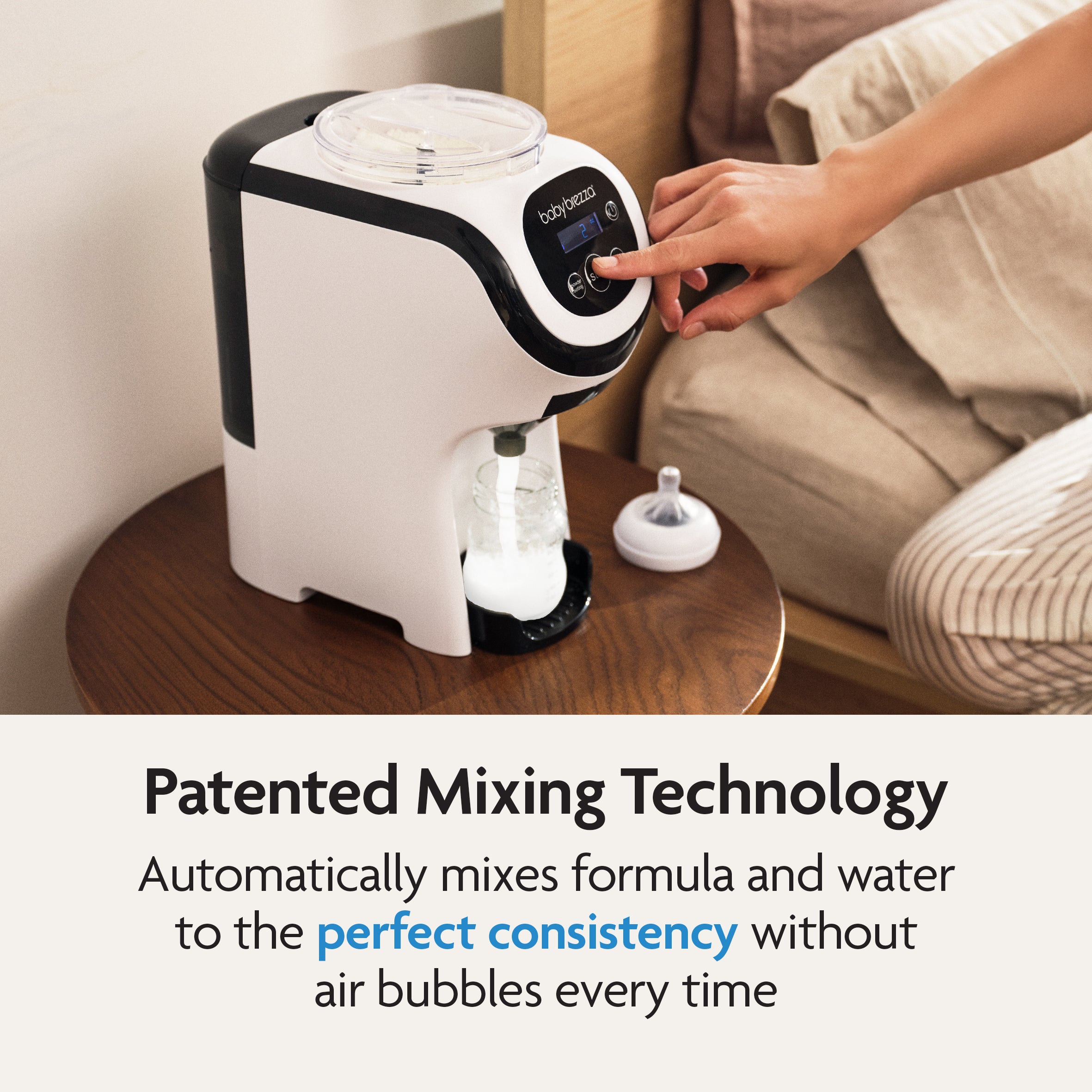 A user presses a button on the Baby Brezza UK BUNDLE Formula Pro Mini White preparing formula on a wooden table. Text below highlights its patented mixing tech for smooth, air bubble-free formula and features the SuperQuick Steriliser Black. - product thumbnail