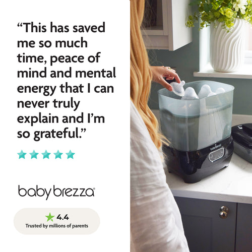 A woman loads bottles into the Baby Brezza UK BUNDLE Steriliser Dryer Advanced Black & Bottle & Breast Milk Warmer, a trusted favorite with glowing reviews, a five-star rating, and a 4.4-star score from millions of parents. - product thumbnail