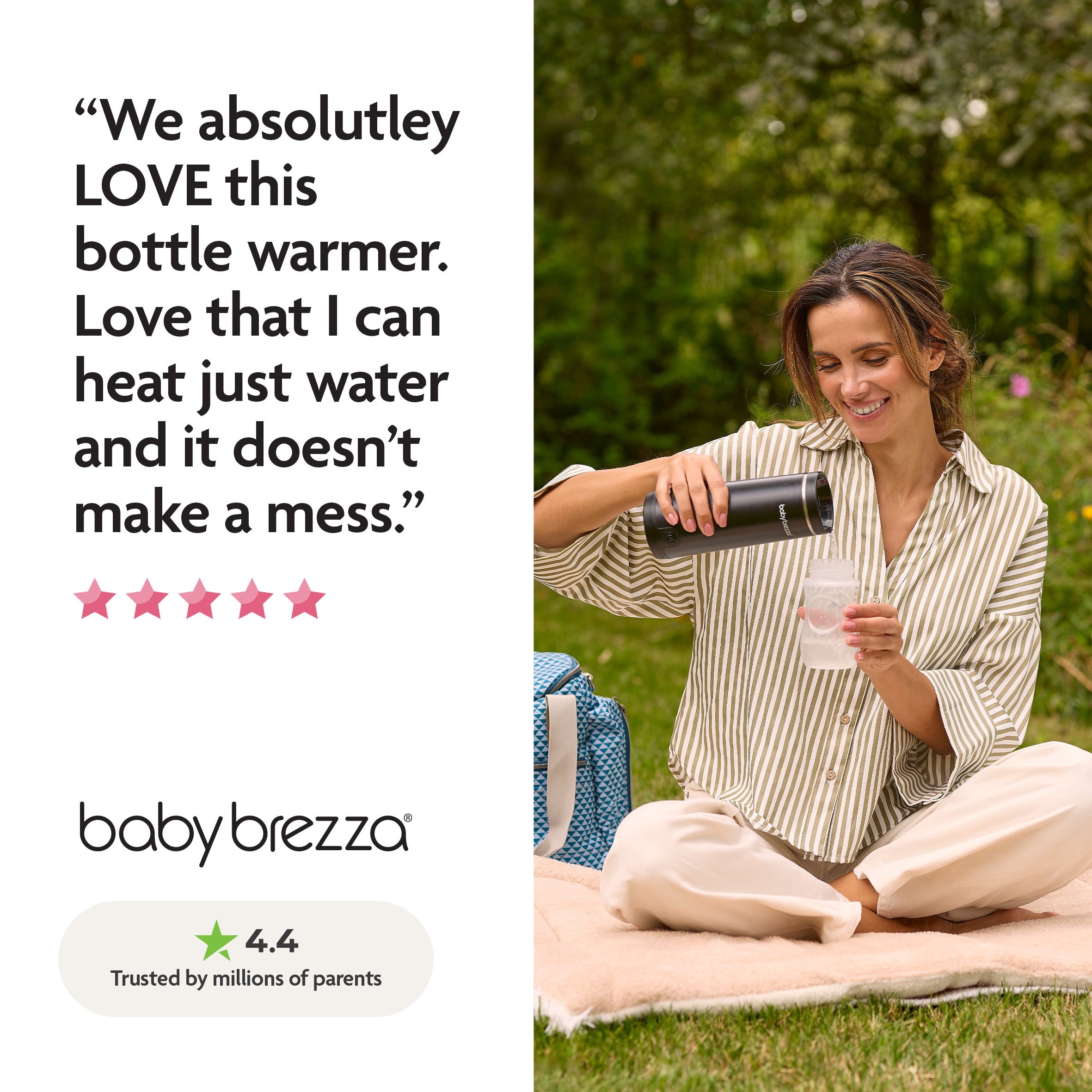 A woman smiles outdoors on a blanket, pouring hot water from the Baby Brezza UK SuperFast Portable Bottle Warmer into a baby bottle. Next to her sits a blue diaper bag and a positive review for the bottle warmer. - product thumbnail