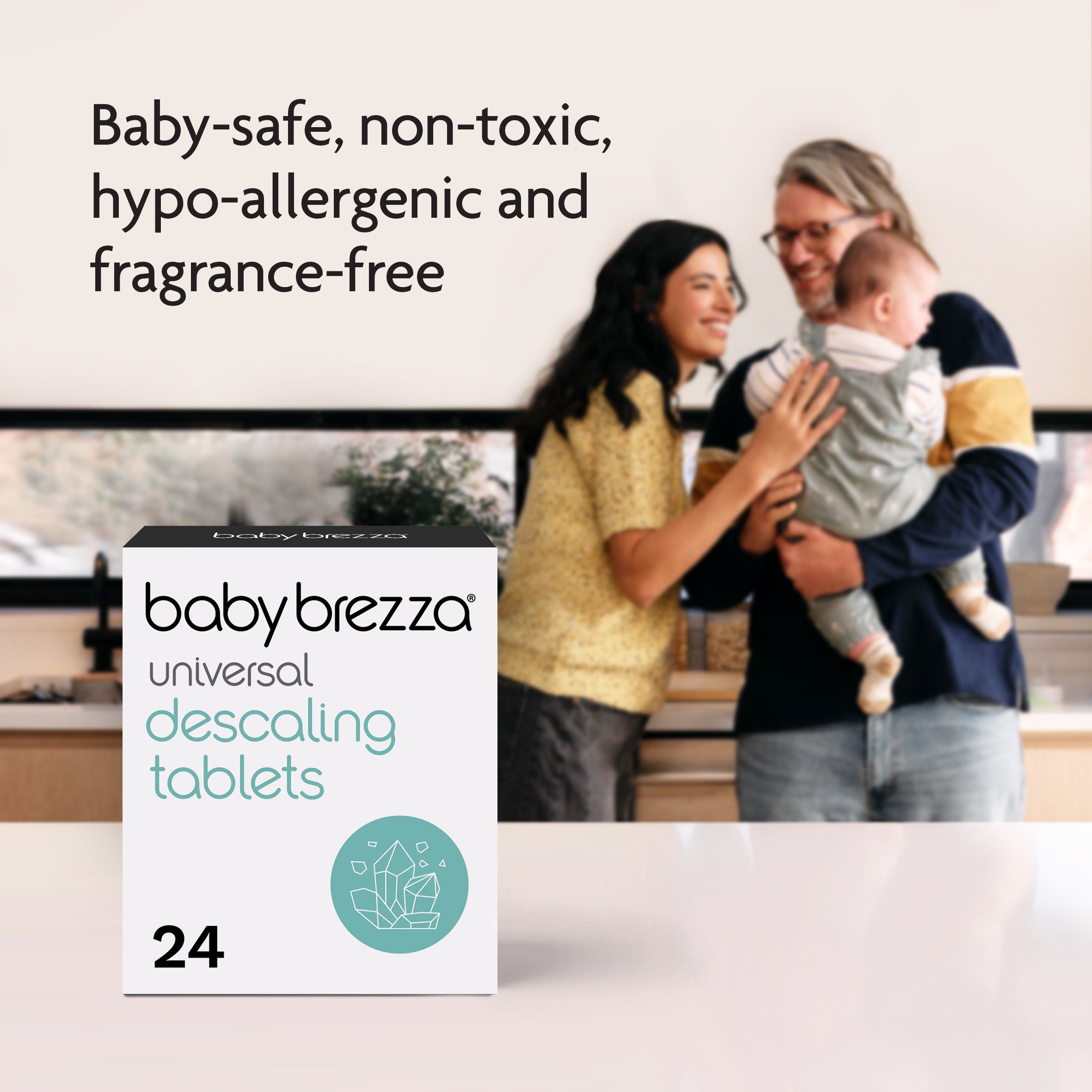 A smiling couple holds a baby in a bright room. Baby Brezza UK Universal Descaling Tablets are shown in the foreground—baby-safe, non-toxic, hypo-allergenic, and fragrance-free for effective limescale removal. - product thumbnail