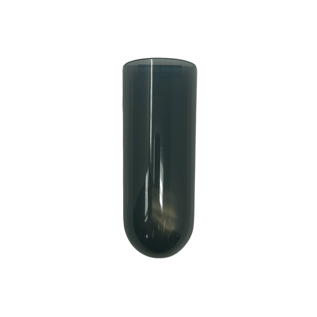 A dark gray, translucent plastic Baby Brezza UK Bottle Warmer Replacement Measuring Cup with a rounded bottom stands upright on a plain white background. - product thumbnail