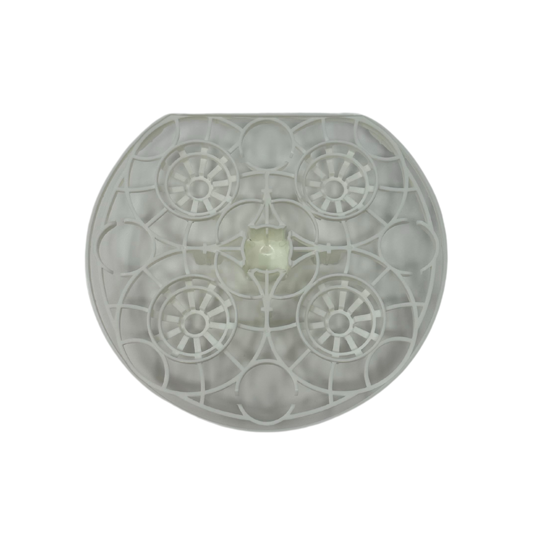 The Baby Brezza UK Bottle Washer Replacement Top Rack is a round, white plastic part with a geometric grid and five circular sections—viewed from above, it features a semicircular top and fits perfectly on the top rack. - product thumbnail