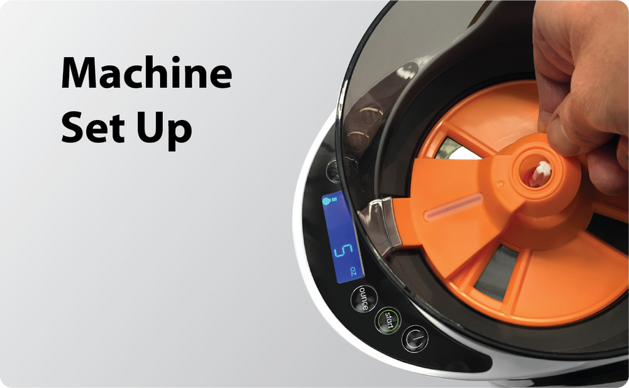 A hand placing an orange component inside a machine with a digital display; text on the left reads Machine Set Up.