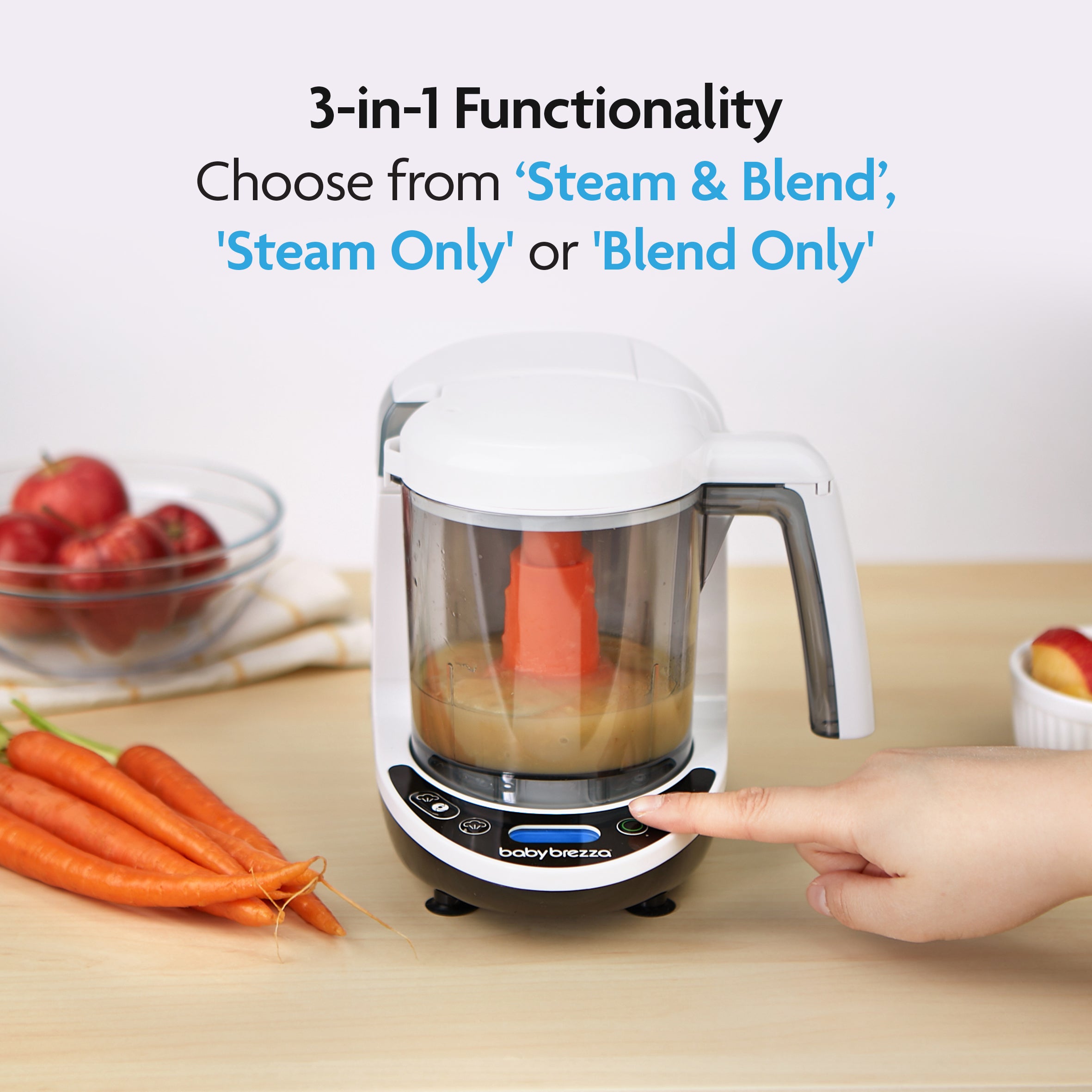 A hand presses a button on the Baby Brezza UK BIG BREZZA BUNDLE - Formula Pro Advanced, Bottle Washer Pro + MUCH MORE! (White), surrounded by pureed food, carrots and apples; it offers 3-in-1 ‘Steam & Blend’, ‘Steam Only’ or ‘Blend Only’ modes. - product thumbnail