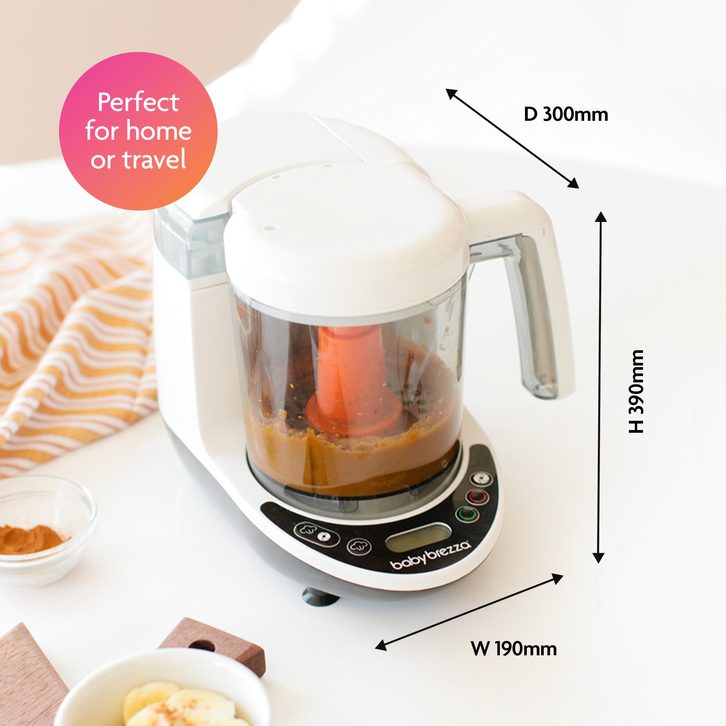 The Baby Brezza UK BIG BREZZA BUNDLE: Formula Pro Advanced, Bottle Washer Pro + MUCH MORE! - All Black sits on a kitchen counter blending puree. Perfect for home or travel. Size: 190mm W x 390mm H x 300mm D. Nearby: striped cloth and food bowls. - product thumbnail