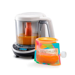 The Baby Brezza UK One Step Food Maker Deluxe, ideal for steaming and blending, sits beside a free reusable pouch—both filled with vibrant homemade orange puree.