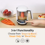A person uses the Baby Brezza UK One Step Food Maker Deluxe + FREE Pouches on a counter with carrots and apples, making homemade baby food with 3-in-1 functions: Steam & Blend, Steam Only, or Blend Only, ideal for preparing fresh meals or filling pouches. - product thumbnail